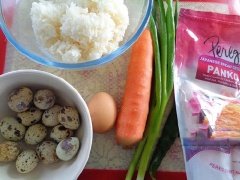 Cà rốt gọt vỏ, rửa sạch rồi bào nhỏ. Trứng cút luộc chín, bóc bỏ vỏ. Trong tô lớn trộn đều cơm nguội, hành lá cắt nhỏ, trứng gà, cà rốt, bột mì và 1 muỗng cà phê bột nêm, 1/2 muỗng cà phê tiêu. Để vào ngăn mát tủ lạnh 30 phút (cách này giúp cơm dẻo sánh để vo viên).