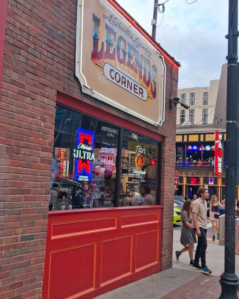 Crowded dance floor filled with lively patrons enjoying live music at Legends Corner