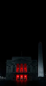 Neoclassical Building Illuminated by Dramatic Red Light at Night