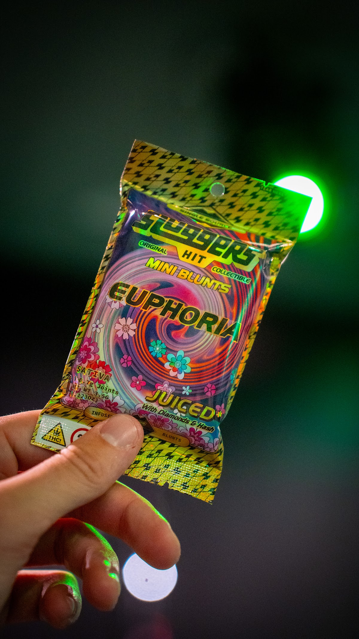 Mini blunts pack under neon light — cannabis product photography