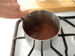 Cho cốc chocolate vào lò vi sóng khoảng 30 giây cho chảy, rồi lại thêm 10 giây nữa để đảm bảo chocolate tan chảy hoàn toàn. Nếu không có lò vi sóng bạn có thể cho chocolate vào nồi và đun trên bếp đến khi chocolate tan chảy hết. Sau đó, thêm sữa, khuấy đều.