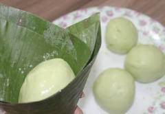 Bột chia làm 6 phần vỏ, nắn mỏng, cho nhân vào giữa bao kín nhân lại (túm sao cho nhân k bị lòi ra ngoài), sau đó vo tròn áo dầu ăn bên ngoài bột cho bột không dính lá khi hấp. Ta chuẩn bị lá chuối luộc sơ để lá được đẹp và dễ gói, cắt lá chuối cho gọn cuộn lại thành hình cái phễu cho viên bột vào giữa, gấp mí lá lại, gói đến khi hết bánh.