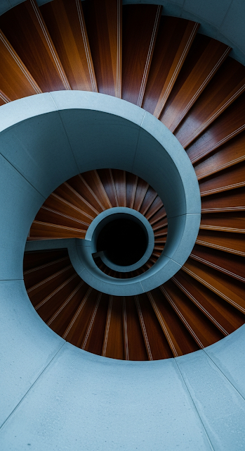 Abstract Top-Down View of a Modern Architectural Spiral Staircase with Wood Treads and Concrete Railing - Free mobile Wallpaper