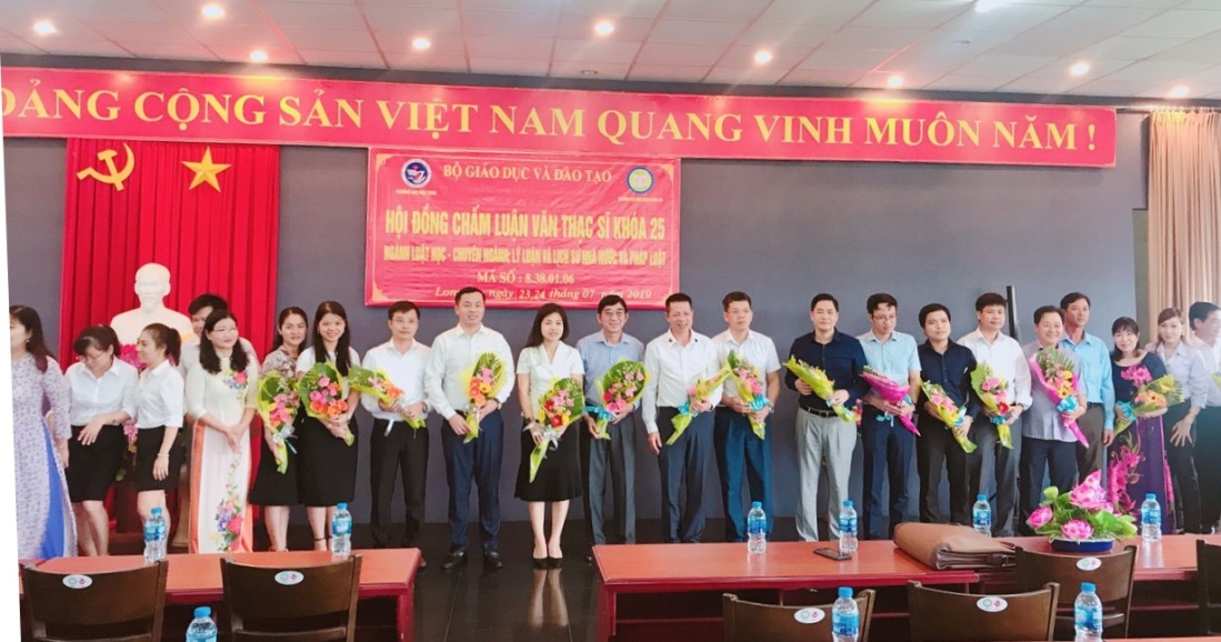 Học viên tặng hoa và chụp ảnh lưu niệm cùng hội đồng. Ảnh Quốc Thậm