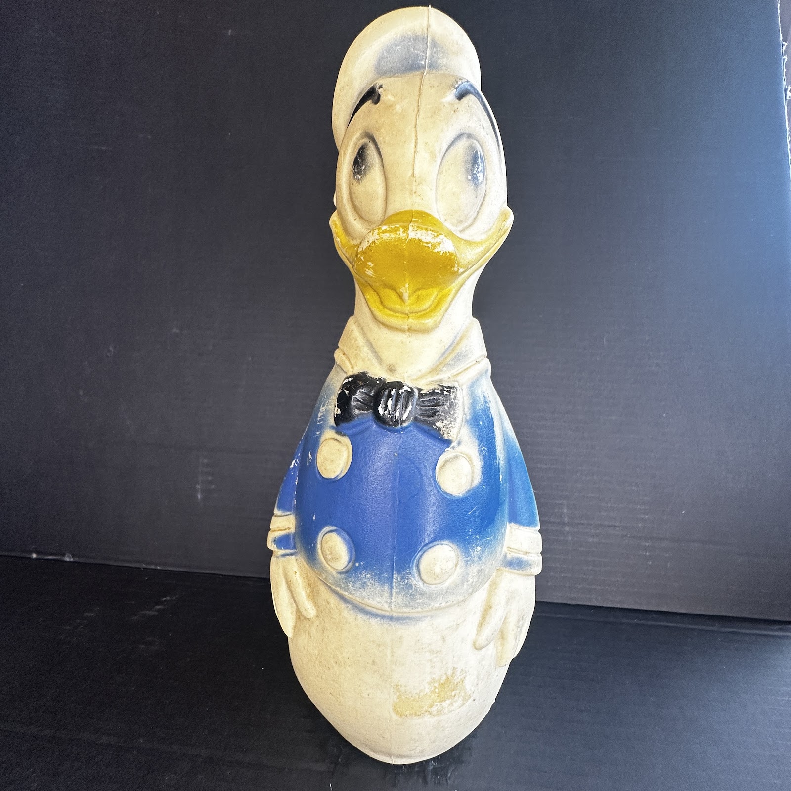 Vintage rubber Donald Duck bowling pin toy, 1950s-1960s, wearing blue sailor jacket and white hat, showing age-appropriate yellowing and paint wear