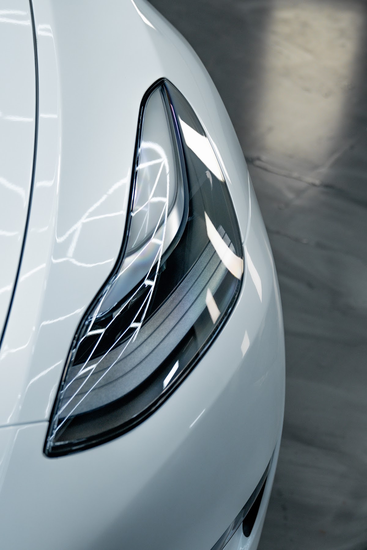 Tesla Model Y headlight detail after paint correction at ZAutoCare