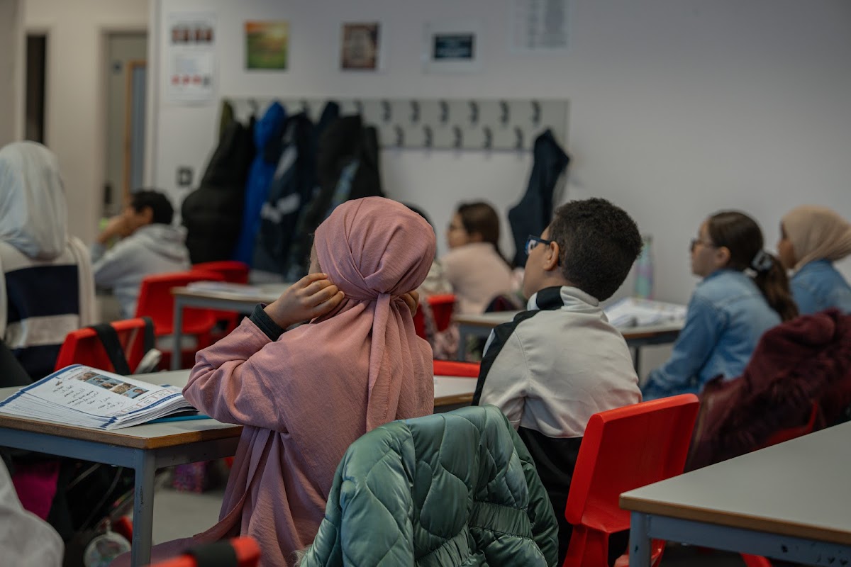 Students in class with books open