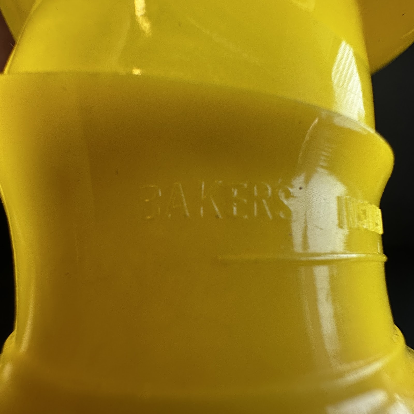 Vintage yellow injection-molded plastic Goofy character hat with embossed Baker's promotional branding, circa 1980s–1990s