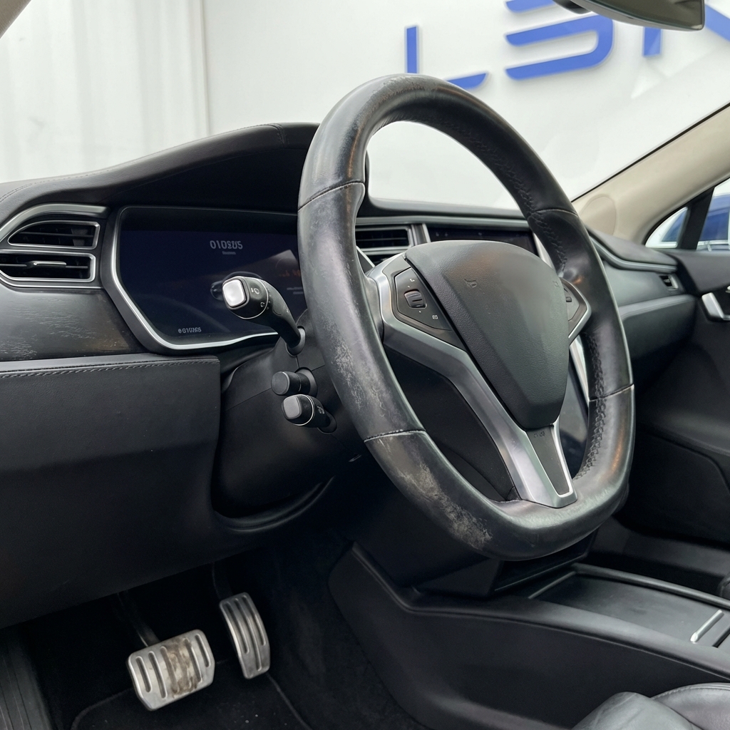 Close up full frame view of a car dashboard with worn steering wheel rim and pedals highlighting wear patterns who gives the best car valuations