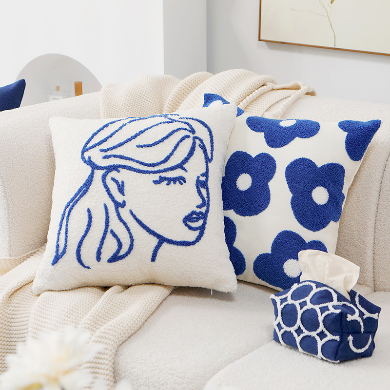 Cushion cover with embroidered daisy motif