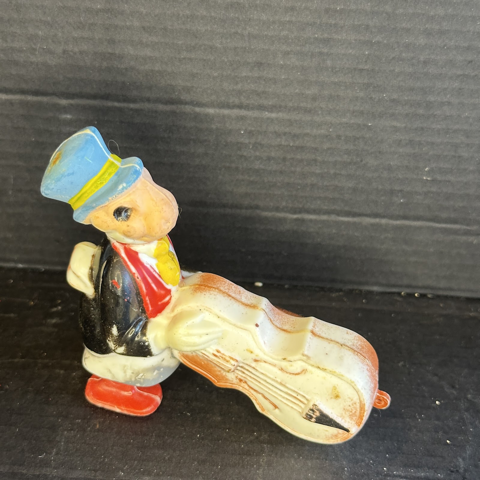Vintage ceramic Jiminy Cricket figurine playing a double bass, circa late 1940s to 1950s, hand-painted in classic Disney style