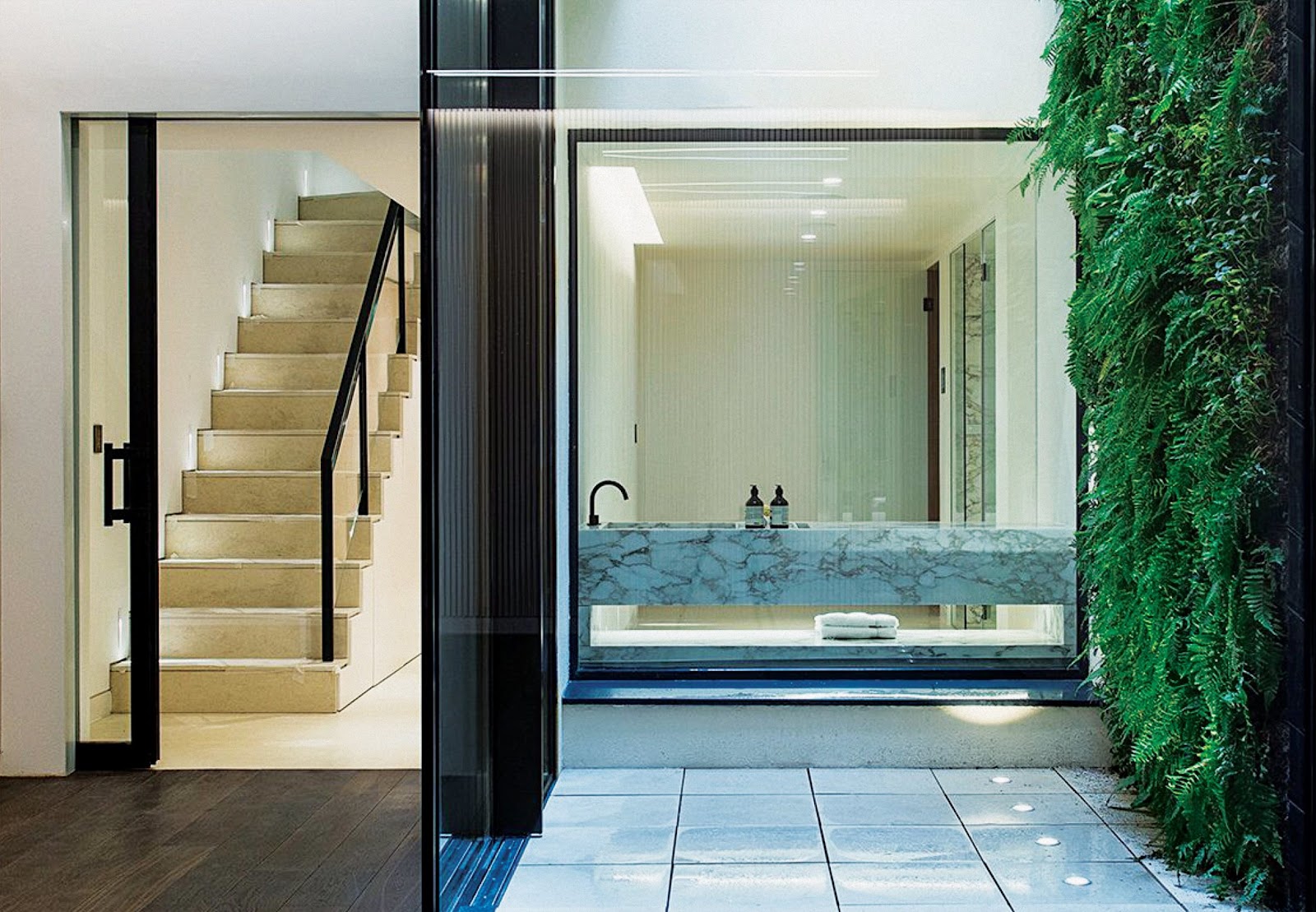 Modern luxury bathroom with marble sink and glass elements