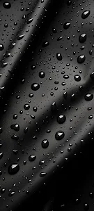 Reflective Water Droplets on Dark Black Textured Surface