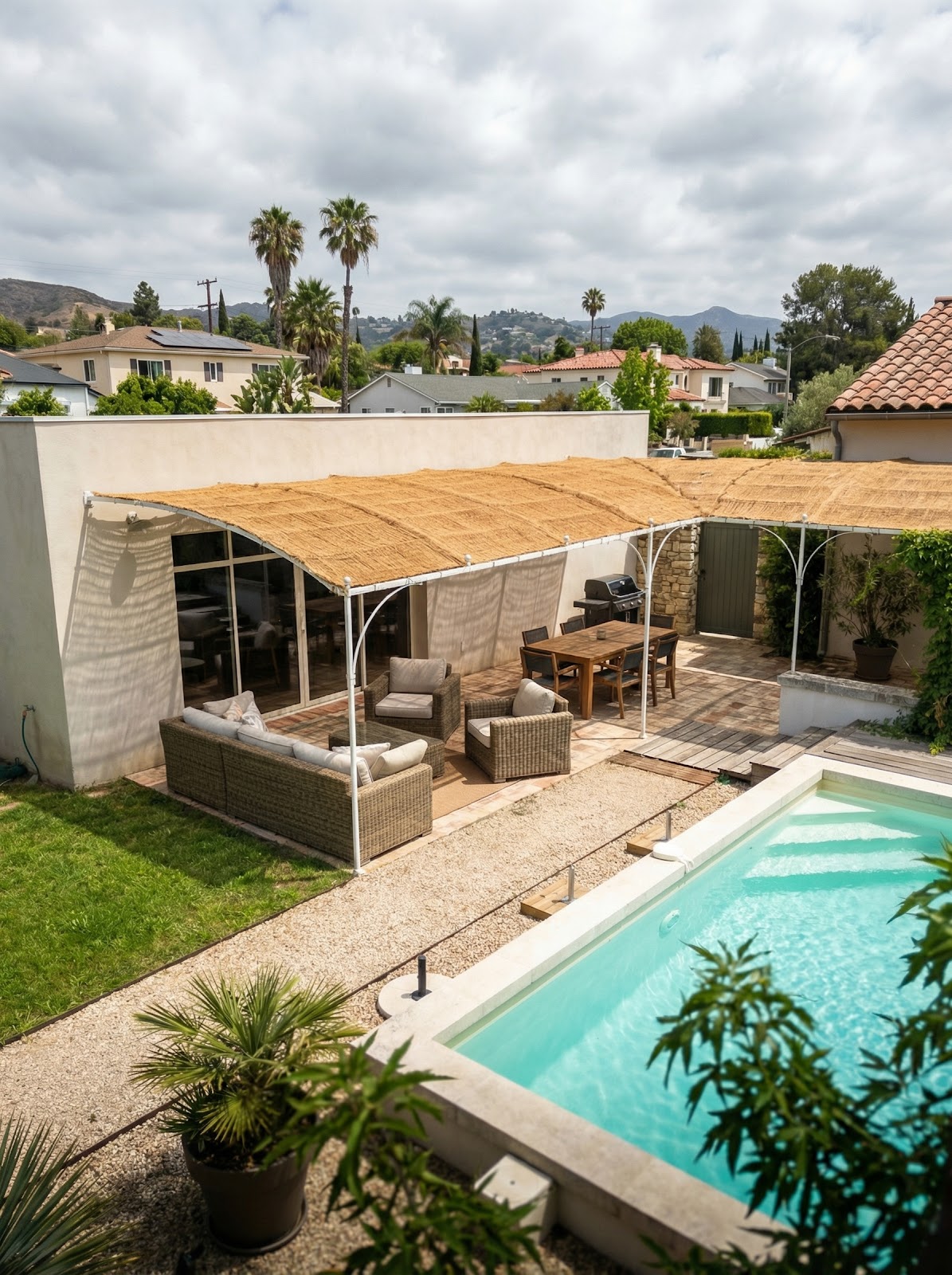 Poolside patio with large coir shade canopy for lounge and dining areas