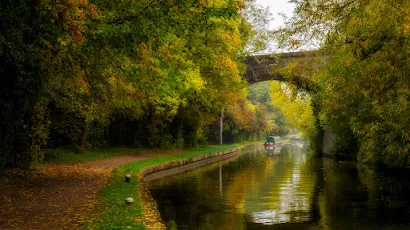 Canal Under Stone Bridge in Autumn 4K Desktop & Mobile Wallpaper Background