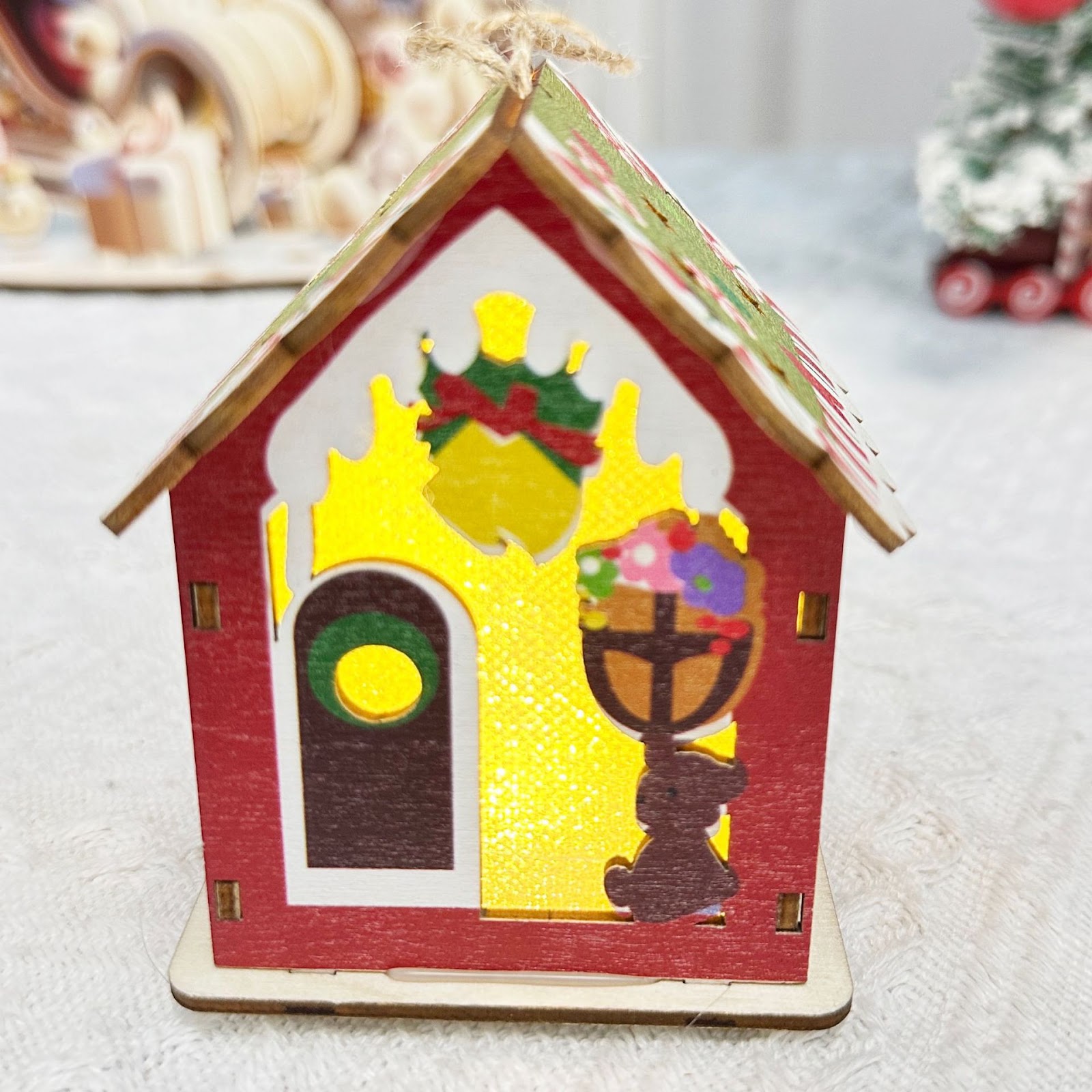 Illuminated wooden house for Christmas table decoration