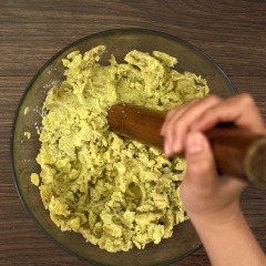 Vớt khoai ra để nguội rồi lột sạch vỏ, sau đó dùng chày giã nhuyễn khoai. Cho thêm vào 40gr đường cát, 200gr cơm dừa bào sợi dùng tay trộn đều hỗn hợp.
