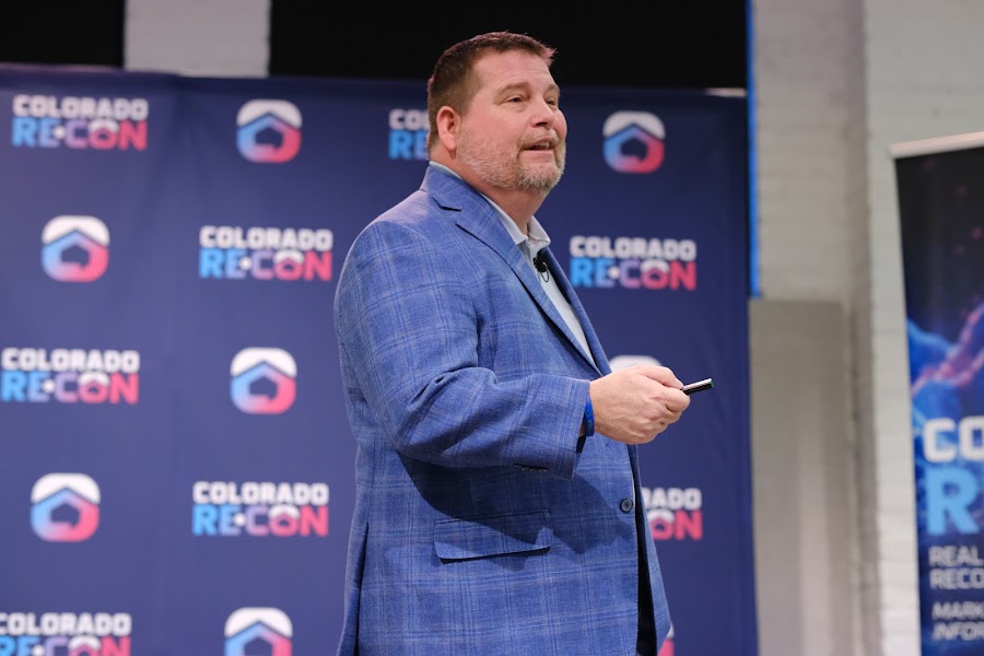 Speaker on stage at a past Colorado RE•CON event