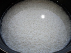 Vo sạch gạo, cho gạo vào nồi, đổ nước ngang mặt gạo rồi ngâm khoảng 10 phút.