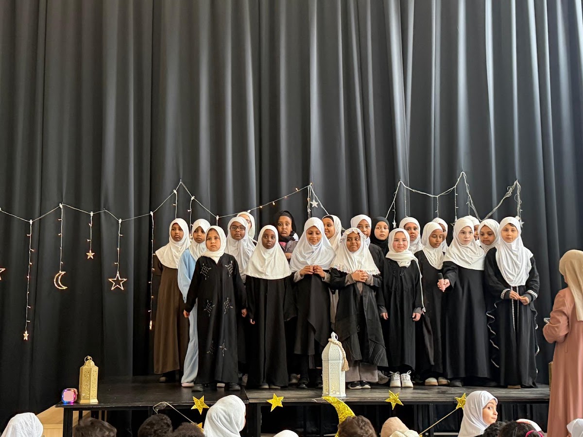 Girls reciting on stage at the Ramadan celebration
