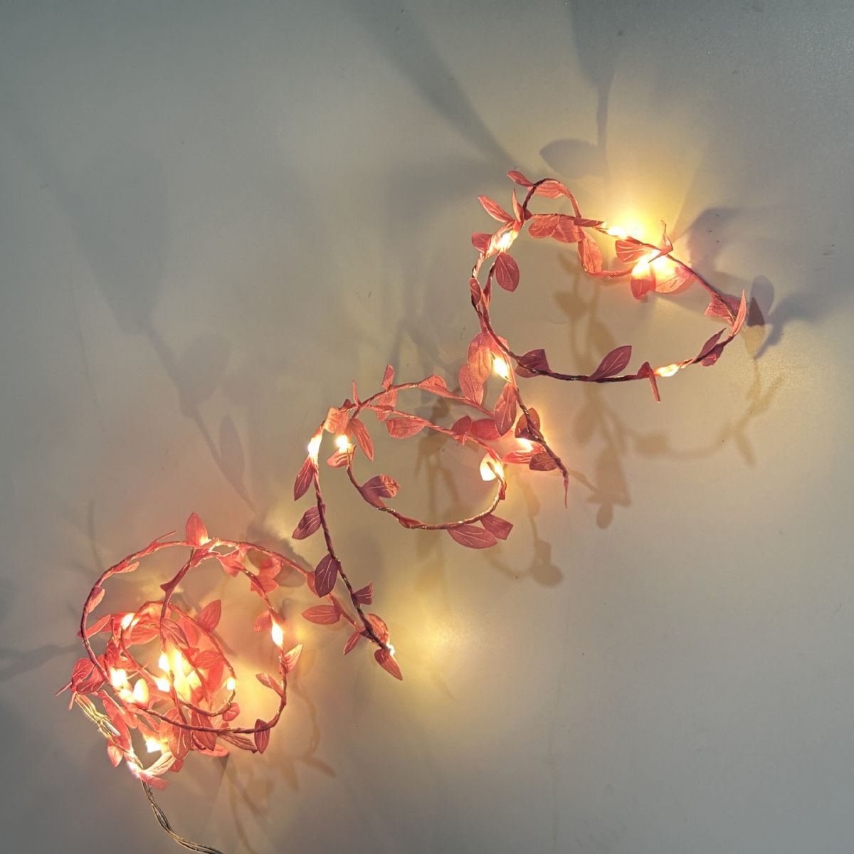 LED string lights with artificial leaves
