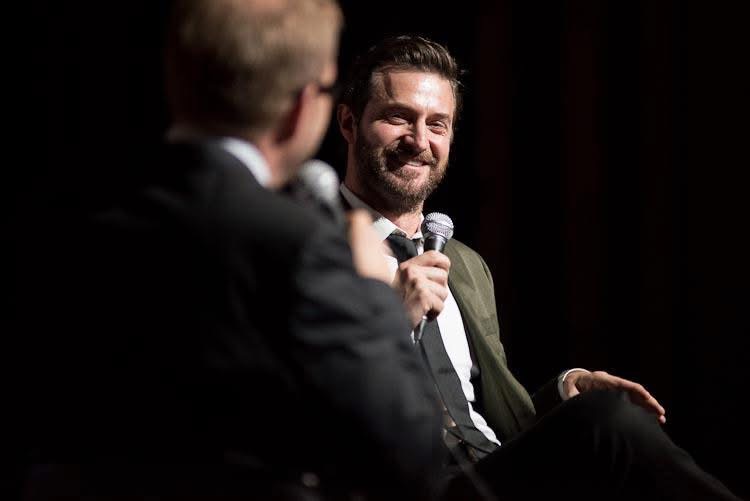 Richard Armitage laughing on stage with Oscar Hillerstrom at Popcorn Taxi