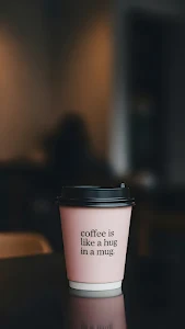 Minimalist Coffee Cup with Quote in a Warm Cafe Setting