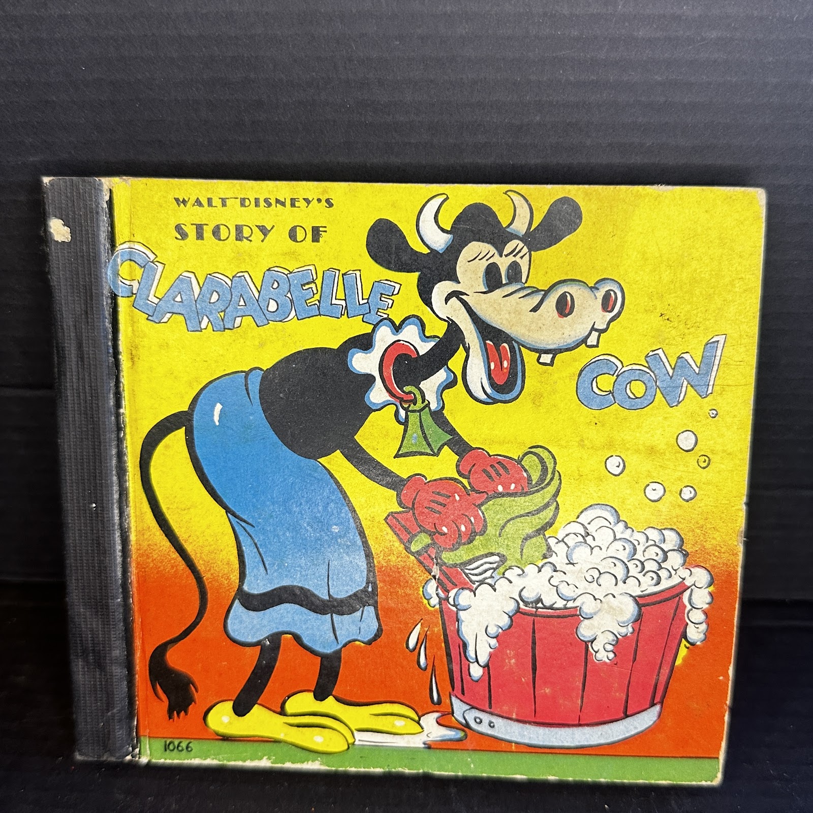 Vintage Disney hardcover storybook featuring Clarabelle Cow, circa 1938–1940, measuring approximately 5.5 by 6 inches, with visible spine wear