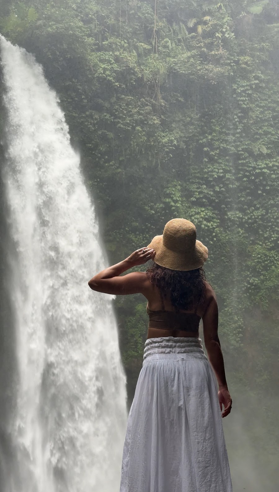 Standing beneath the jungle waterfall during the sacred waterfall experience