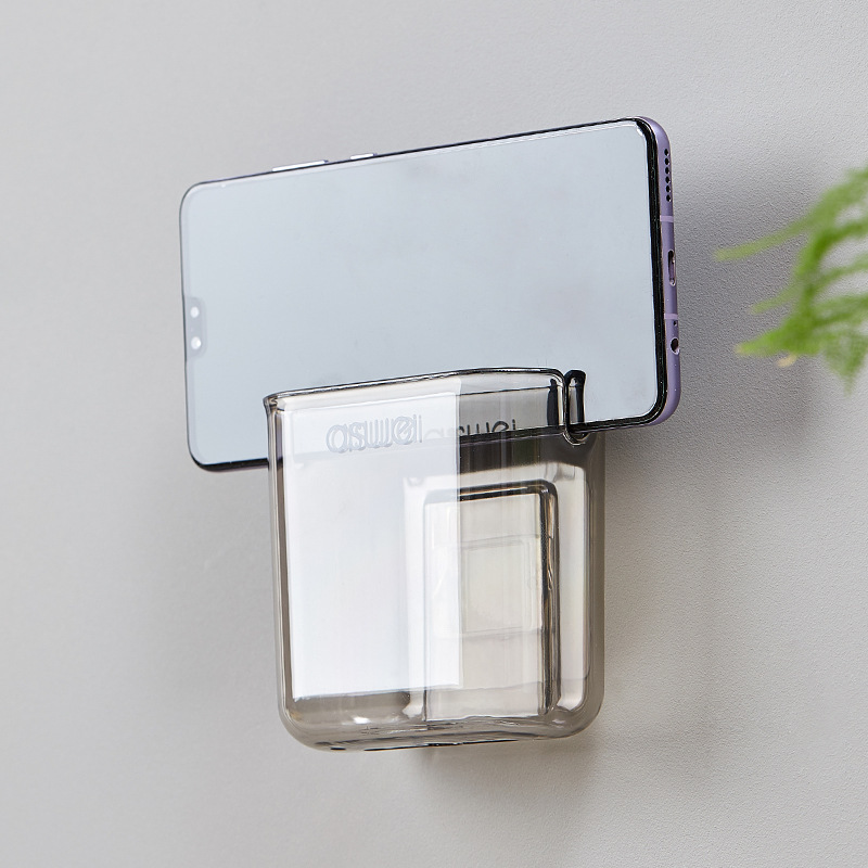 Wall-mounted storage box for remote controls and mobile phones