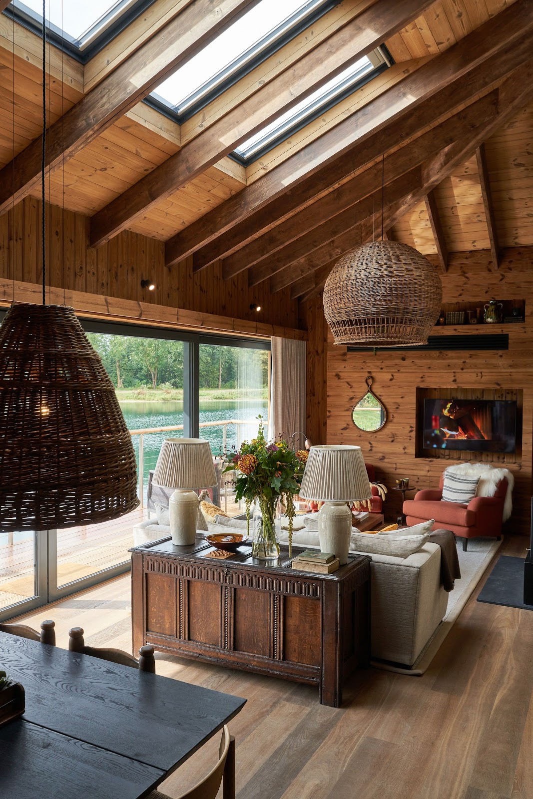 A Cotswold stone barn conversion on the western escarpment, vaulted oak roof and glazed gable looking out toward the Severn vale