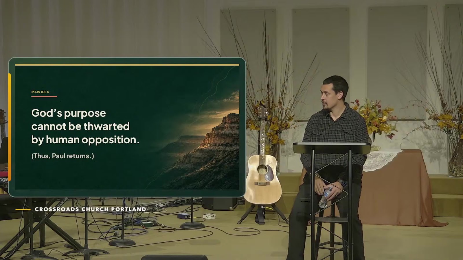 Speaker teaching beside a Crossroads sermon slide during the September 13 service.