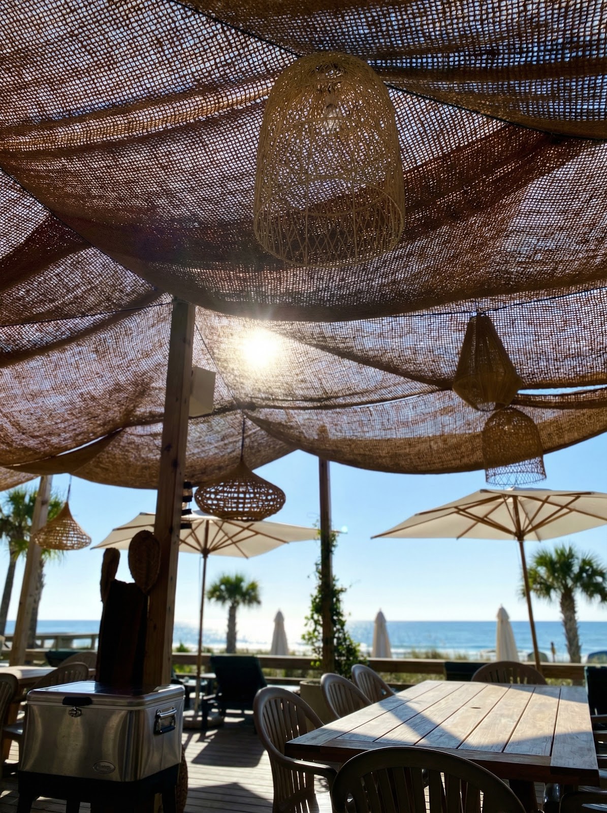 Beach restaurant coir shade sails with woven pendant lights