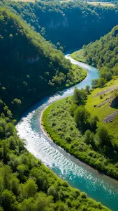 Winding Turquoise River Through Lush Green Valley