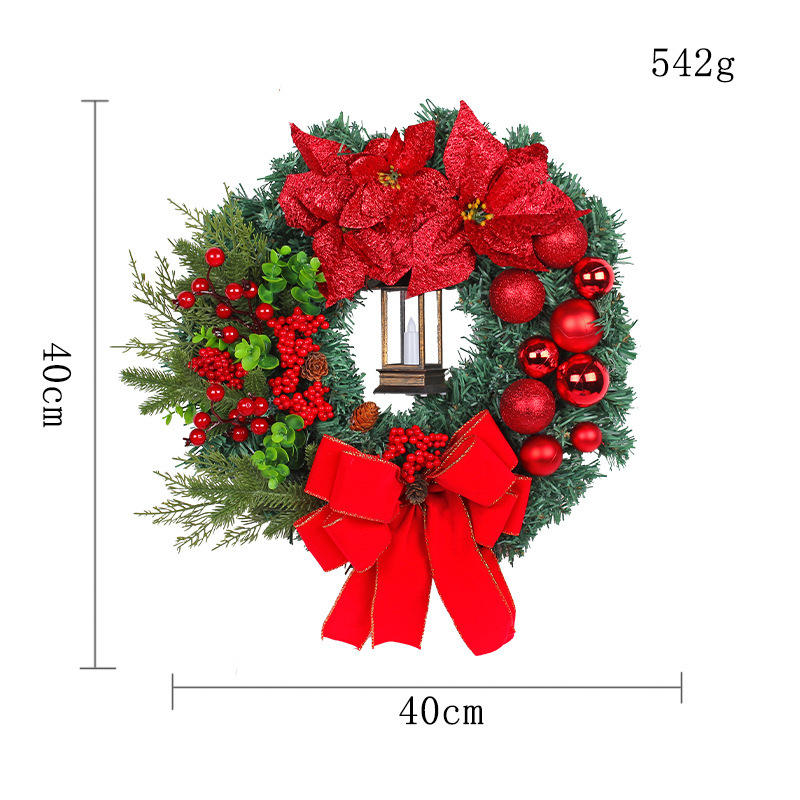 Christmas wreath with decorative lantern and red flowers