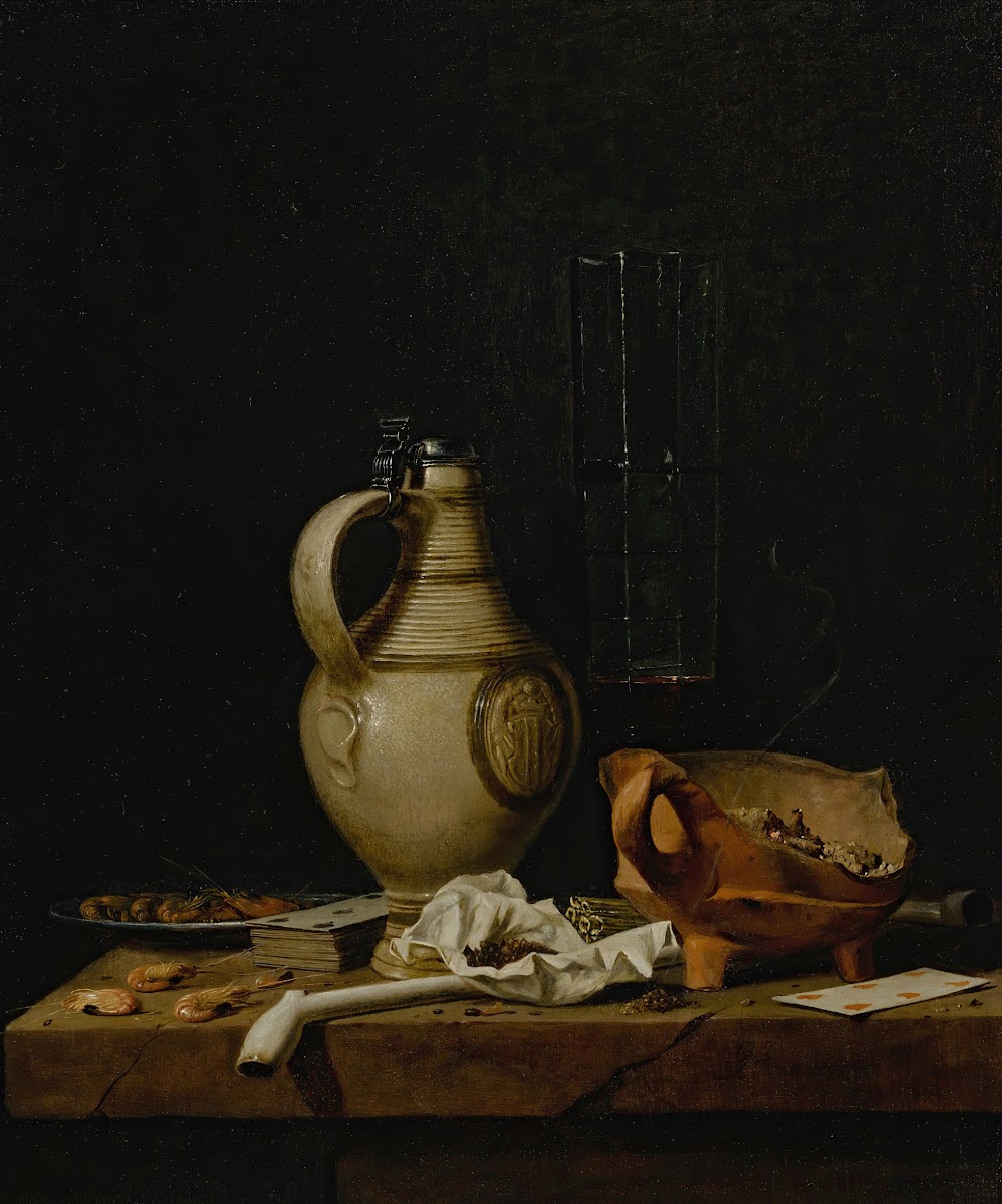 A Still Life With A Stoneware Jug A Glass Of Beer Playing Cards And Smokers Requ