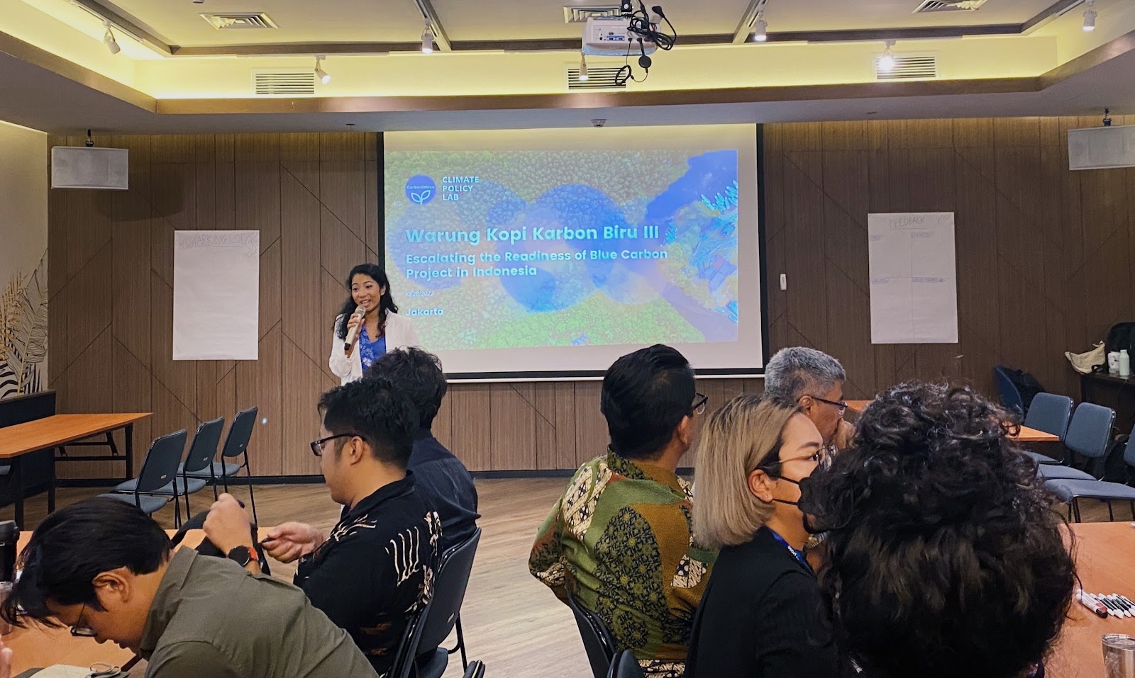 Screen displaying Blue Carbon Projects in Indonesia, Warkop Karbon Biru in a conference room (Blue Carbon Ecosystem Conservation Indonesia)