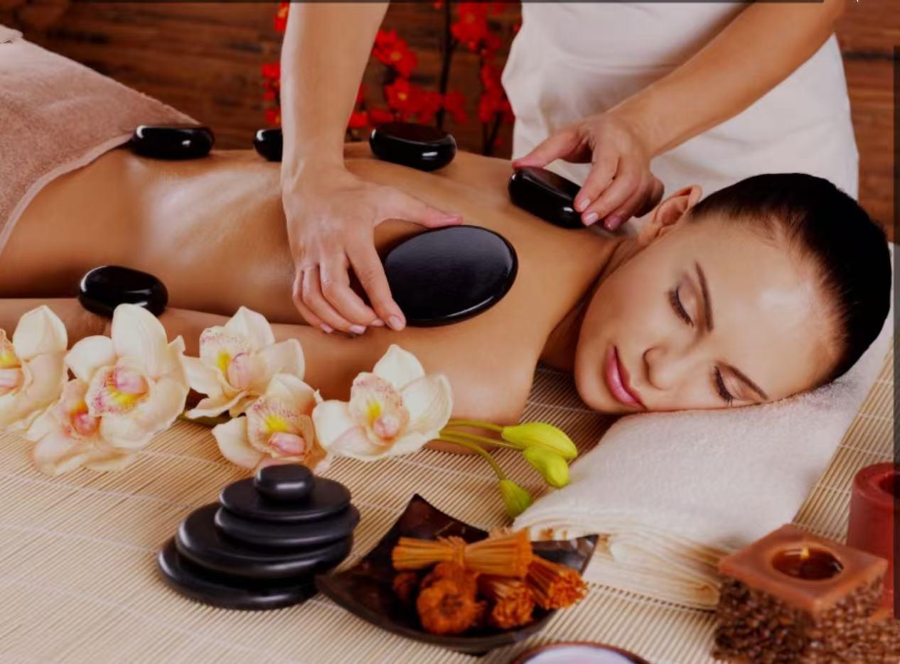 Warm massage stones on a treatment table