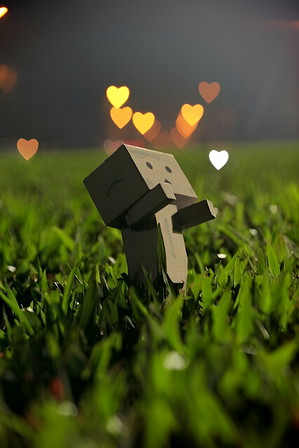 Cardboard Robot in Grass with Floating Heart Bokeh Lights - Free mobile Wallpaper