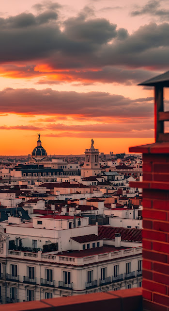 Rooftop View of Madrid Cityscape Silhouette against Fiery Sunset Sky - Free mobile Wallpaper