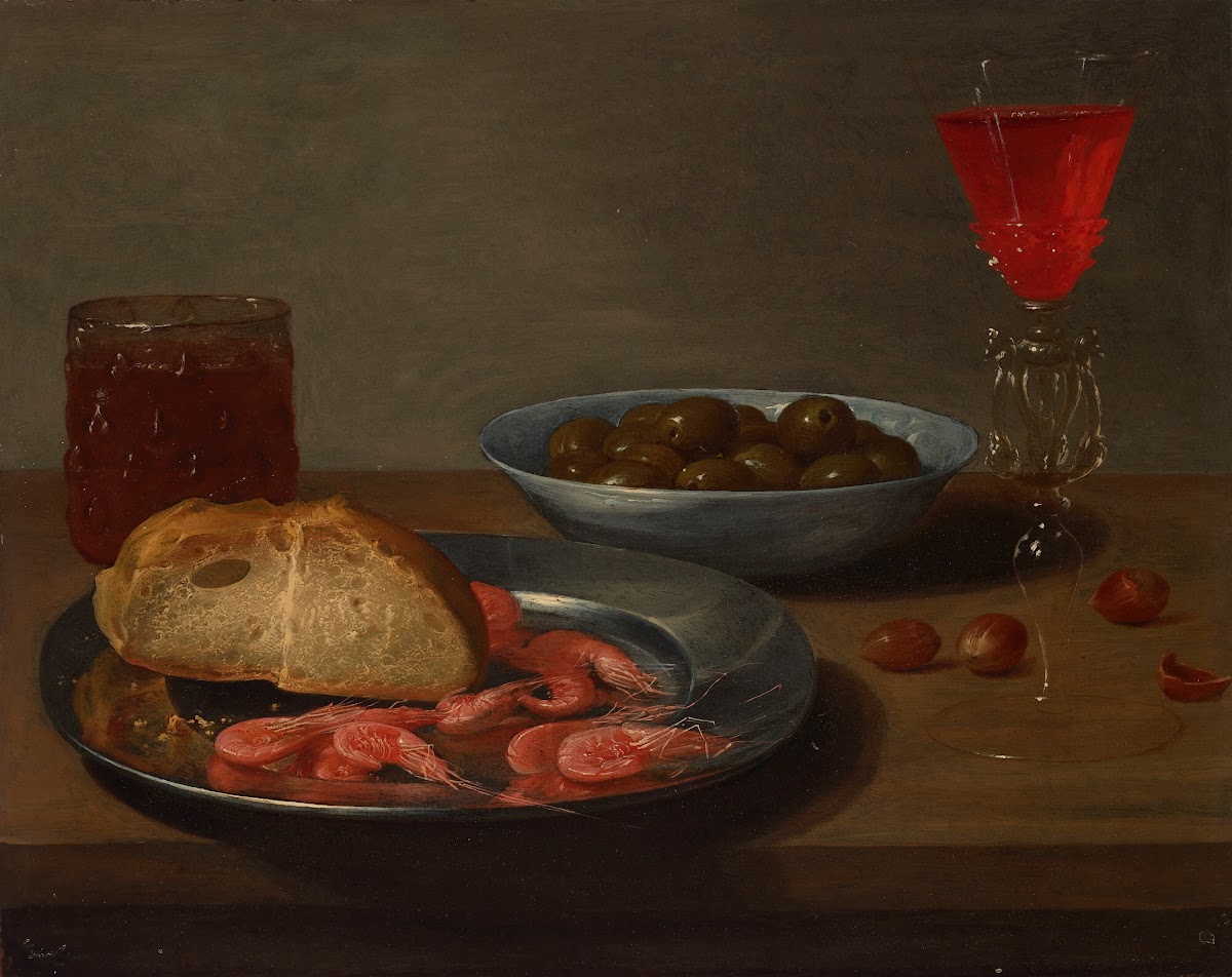 A plate with prawns and a roll a bowl with olives a façon de Venise a glass of b