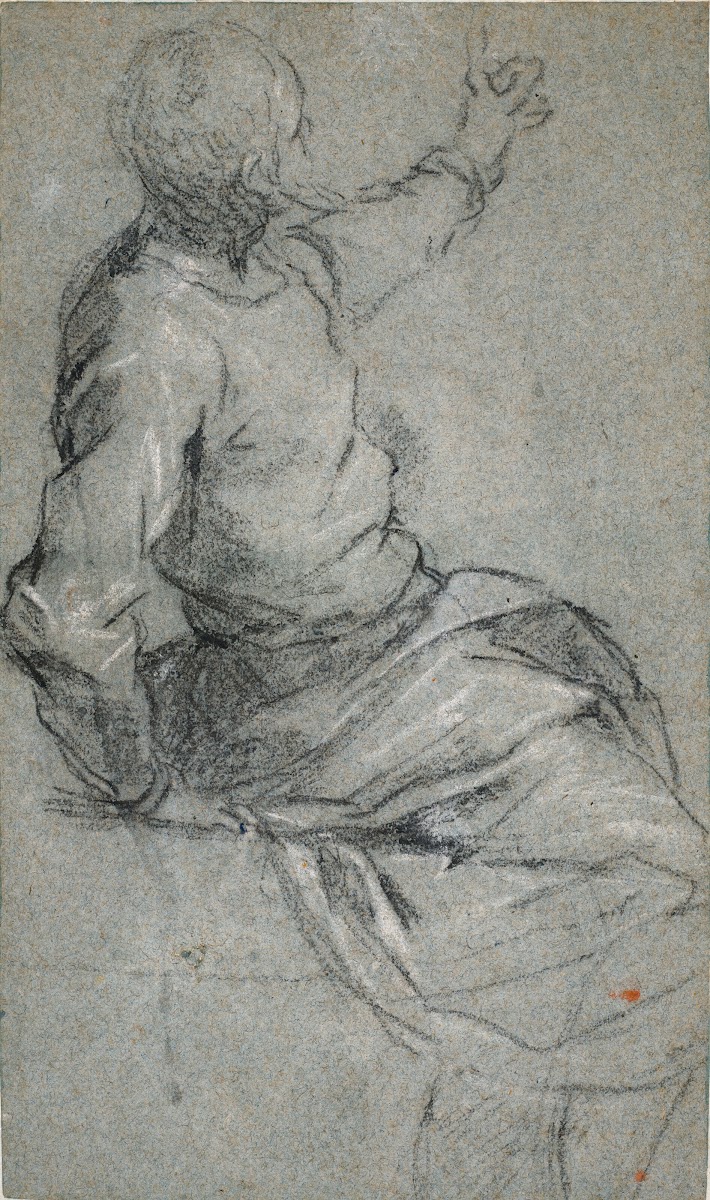 A bearded man seated his left arm raised