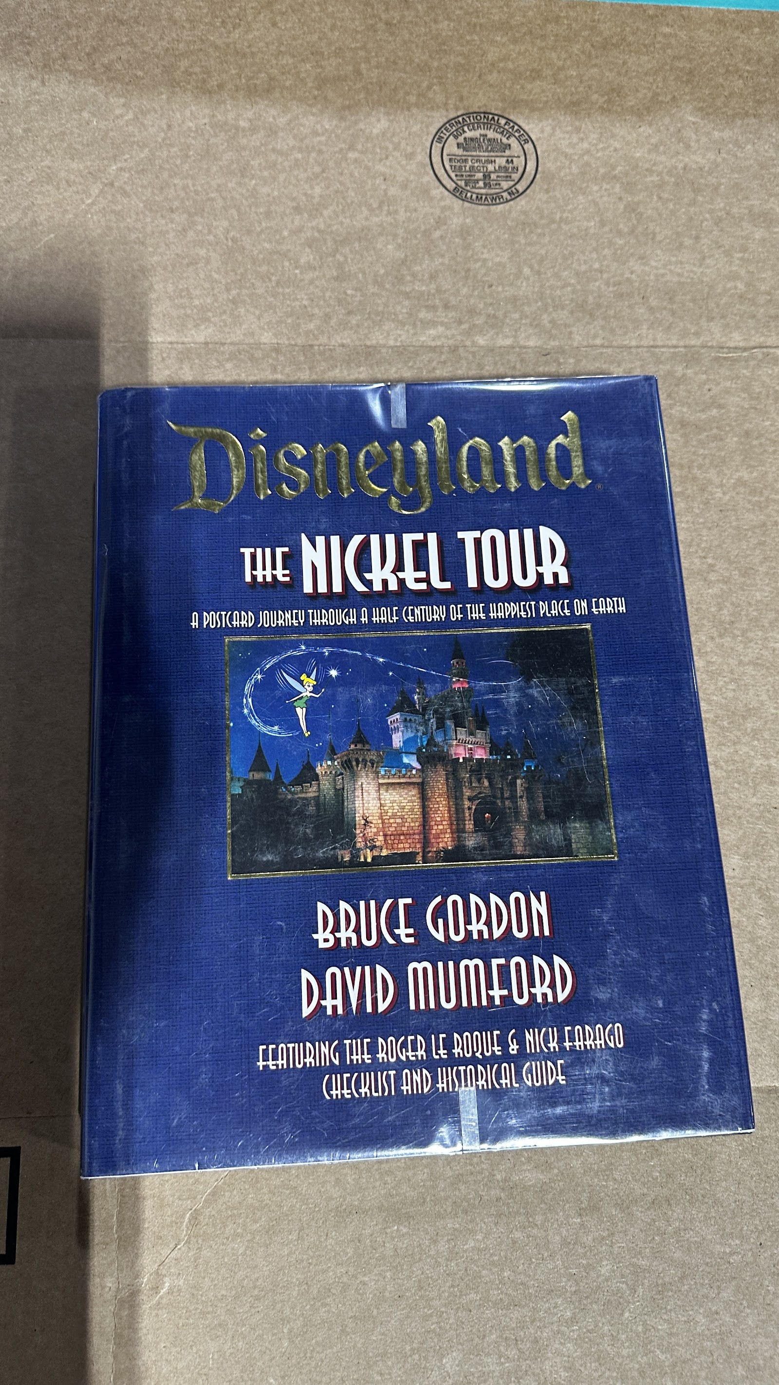 Vintage Disneyland "The Nickel Tour" souvenir book from the 1950s–1960s, cover showing moderate shelf wear with intact spine and colorful park imagery