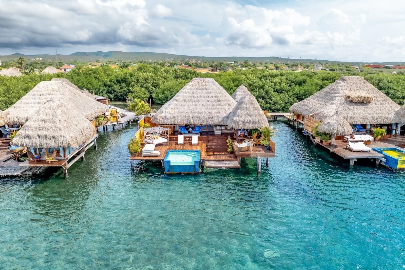 Romantic overwater villa at Aruba Ocean Villas in Savaneta, surrounded by calm turquoise Caribbean water.