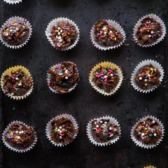 Cho ngũ cốc, bơ đậu phộng, chocolate tan chảy trộn đều với nhau. Múc hỗn hợp vào khuôn cupcake đã chuẩn bị, rắc cốm tùy thích lên trên và để khuôn ở nơi mát mẻ như tủ lạnh cho đông lại.