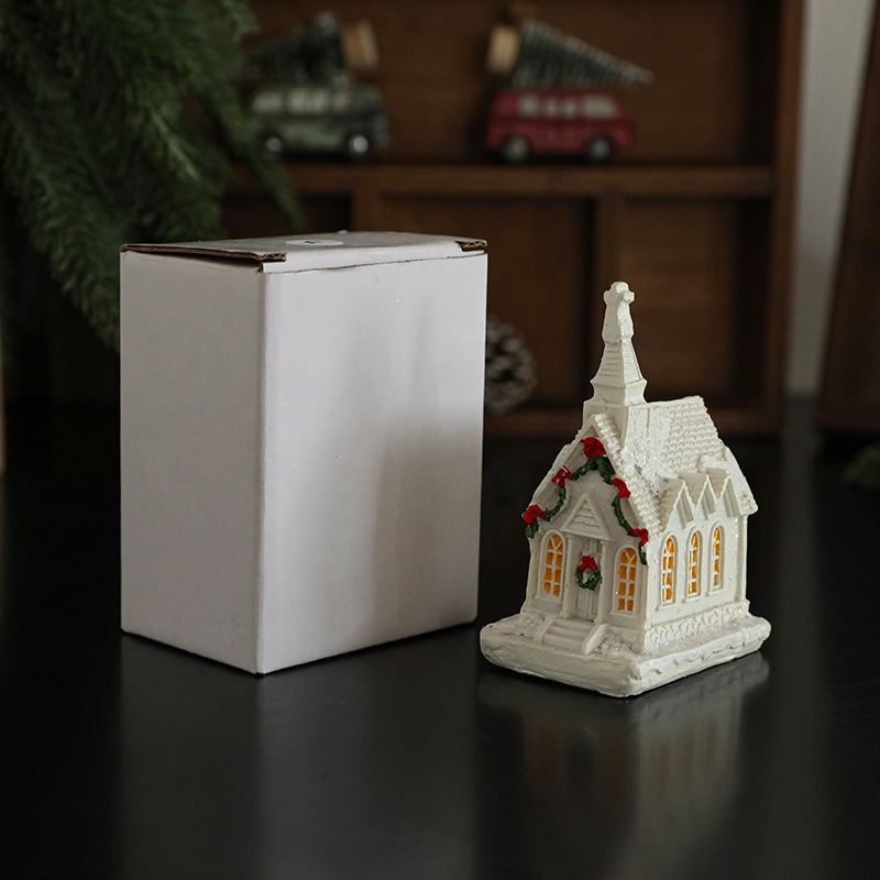 Illuminated miniature snow house made of resin