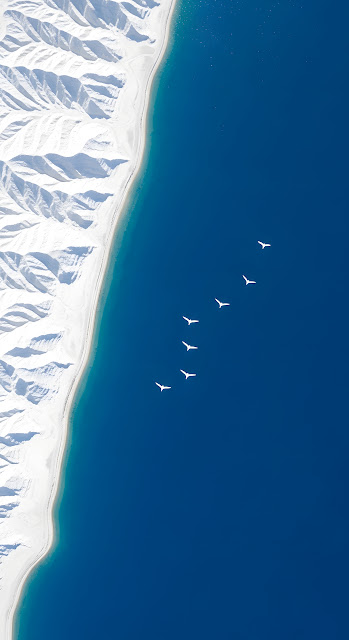 Minimalist Aerial View White Mountains and Deep Blue Sea - Free mobile Wallpaper