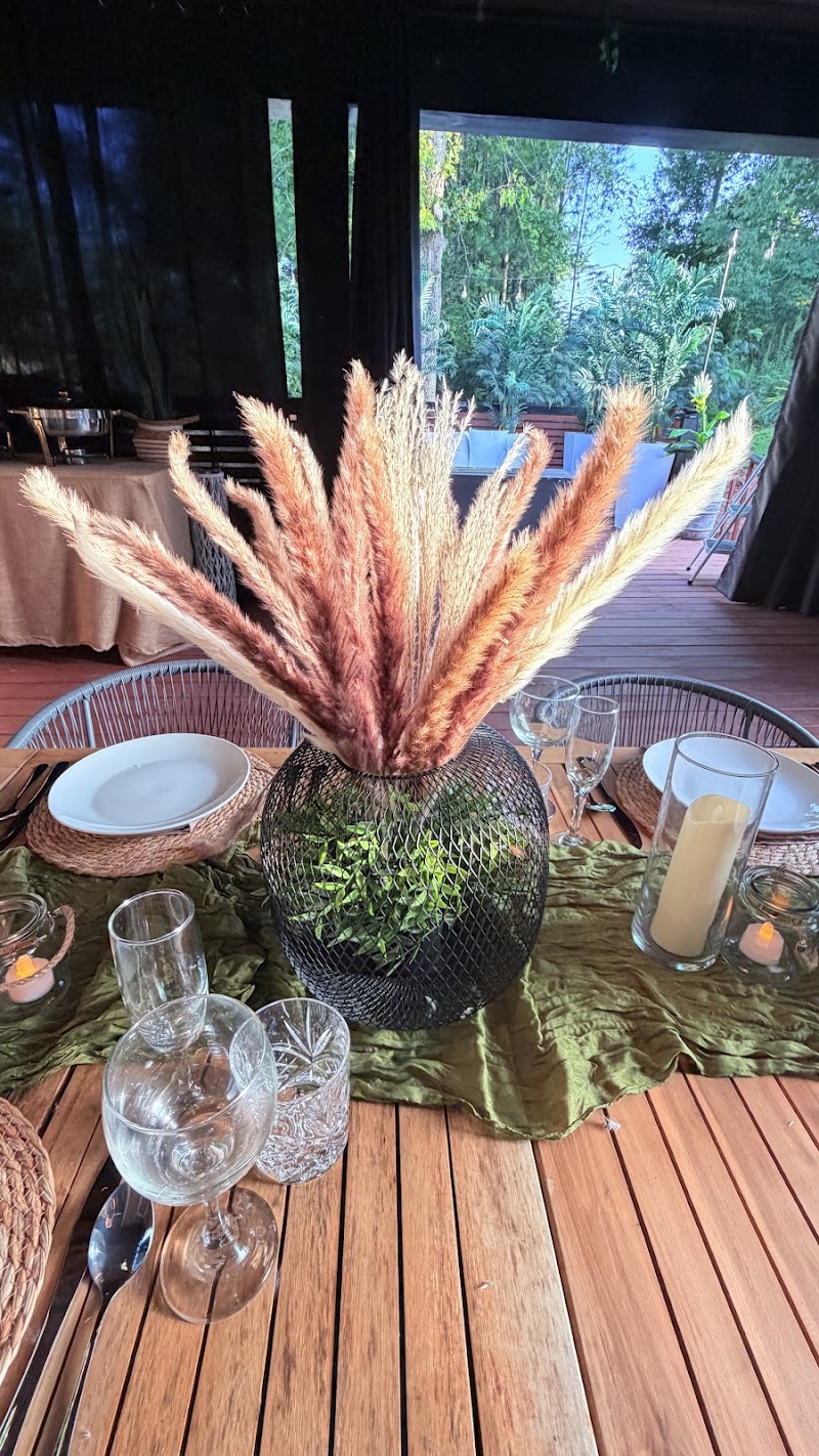 Pampas grass centerpiece with glassware on a wooden table