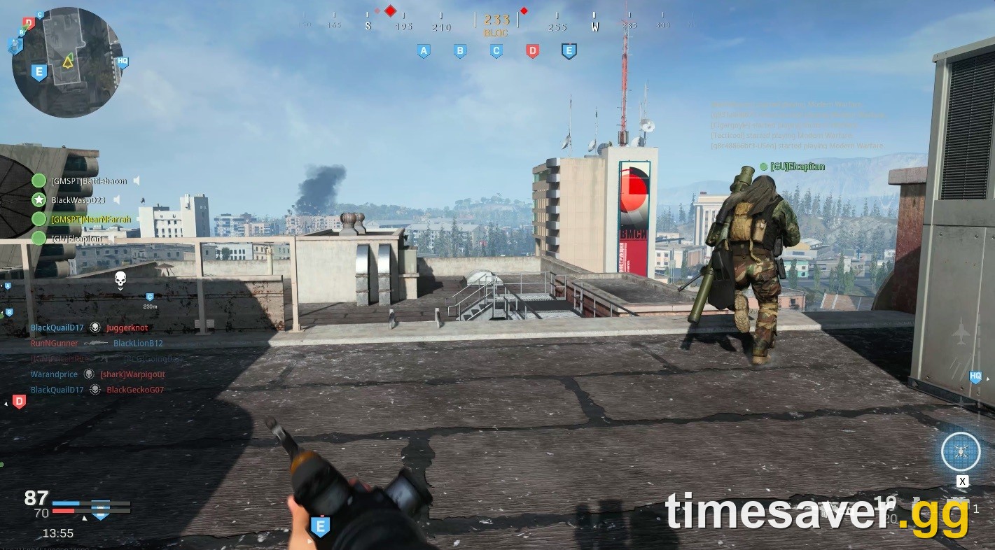 Ground War objective-capture gameplay in Modern Warfare — pushing a rooftop control point with capture flags on the HUD, the same loop Combat Outpost expands
