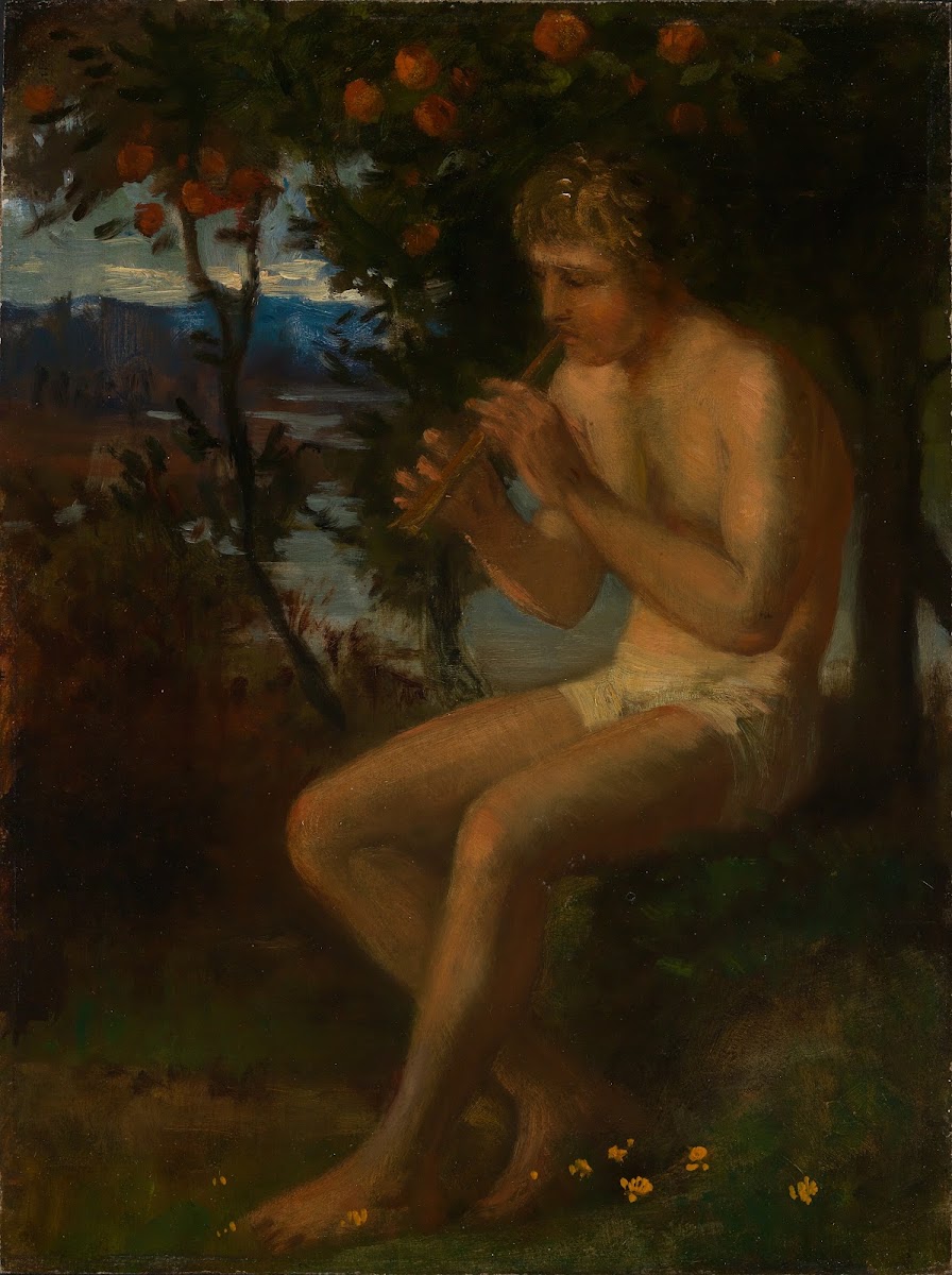 Boy playing the flute by the lake